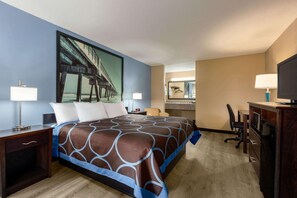A hotel room with a large bed, a desk, a chair, a TV, and a bathroom mirror. - Quality Inn Crestview I-10 Eglin AFB Area (Crestview)