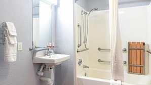 A bathroom with a sink, mirror, shower, and bathtub. - Americas Best Value Inn Irving Dfw Airport South (Irving)