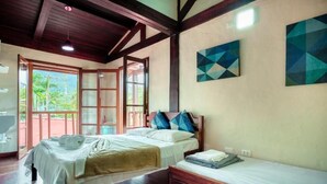 A bedroom with a bed, a bedside table, a window, and a door. - VELINN Pousada Kyrios (São Sebastião)
