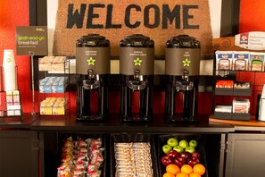 A grab-and-go breakfast station with coffee machines, snacks, and fresh fruit. - Studio6 Columbus, GA Columbus Airport (Columbus)