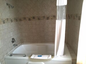 A bathroom with a bathtub, a showerhead, a towel rack, and a shower curtain. - Motel6 Pismo Beach, CA - Pacific Ocean (Pismo Beach)