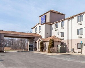 A Sleep Inn Suites hotel with a parking lot and a covered entrance. - Inn & Suites Near I-90 And Ashtabula (Austinburg)