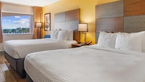 A hotel room with two beds, a view of the ocean, and a modern design. - Beachfront Palms Resort Galveston, an Ascend Collection Hotel (Galveston)