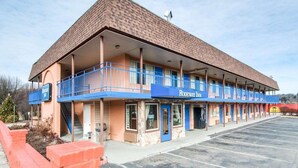 A motel with a two-story structure, a covered parking area, and a visible entrance. - Econo Lodge Galax, VA (Galax)