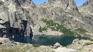 Vuoristoinen maisema, jossa on järvi, kivikkoista maastoa ja niukasti kasvillisuutta.