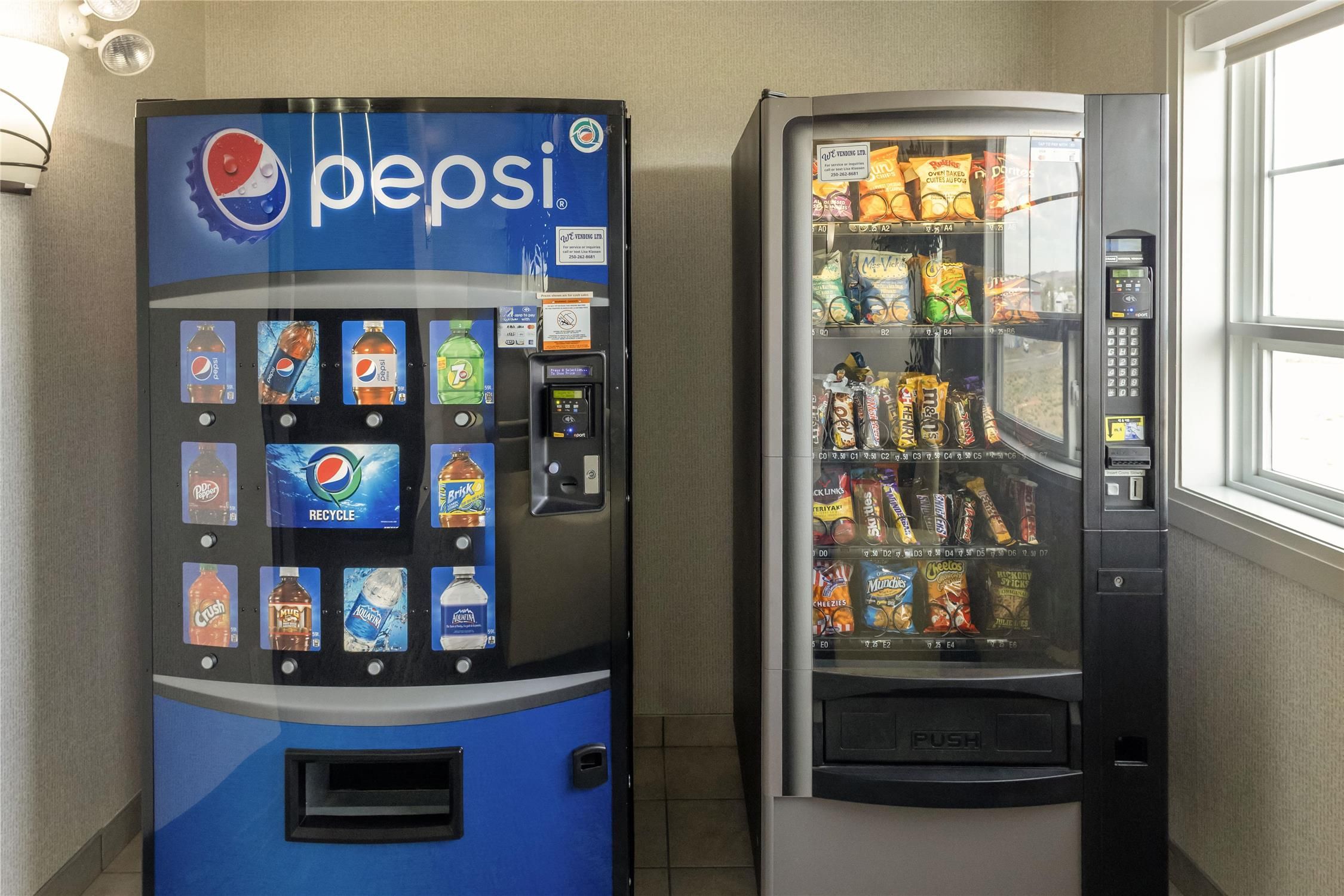 Two vending machines, one for Pepsi and another with snacks.