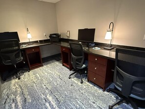 A hotel room with a desk, two chairs, a printer, a telephone, and a lamp. - Best Western Dawson Creek (Dawson Creek)