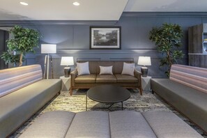 A modern living room with a sofa set, two side tables with lamps, a coffee table, and a framed picture on the wall. - Best Western Dawson Creek (Dawson Creek)