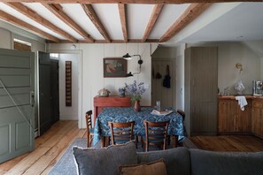 A dining area with a table, chairs, and a painting on the wall. - NEW Design Forward Retreat Near New Hope Stockton (Stockton)