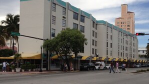 Ein mehrstöckiges Hotel mit schlichter Fassade, großen Fenstern und flachem Dach.