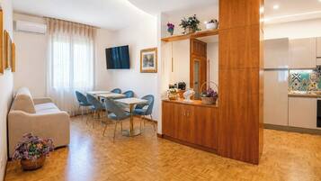 Deluxe Apartment, Balcony, Garden View | Living area | TV