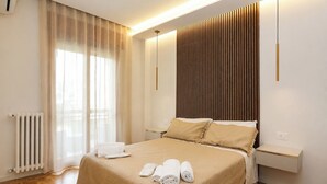 A hotel room with a bed, a bedside table, a radiator, and a window with curtains. - Casa Lucia (Cava de' Tirreni)