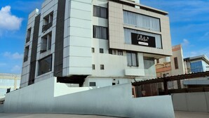 A modern building with a sign that reads 'Collection.' - Super Deluxe Roomhotel Navjivan (Himatnagar)