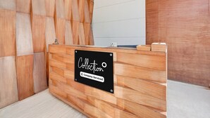 A reception desk with a sign reading 'Collection Company-Serviced.' - Super Deluxe Roomhotel Navjivan (Himatnagar)
