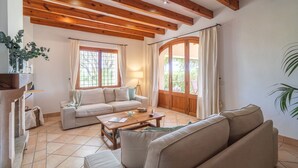 Una sala de estar con un sofá, una mesa de centro y techo de madera.