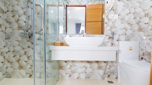 A bathroom with a glass shower enclosure, white sink, and a bathtub. - Mai Hotel Airport (Ho Chi Minh City)