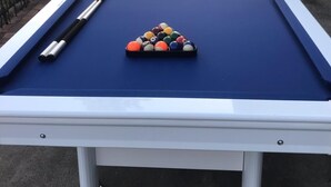 A pool table with balls and cues, surrounded by a railing and street view. - Spacious hotel efficiencies walking distance to all Saratoga has to offer (Saratoga Springs)