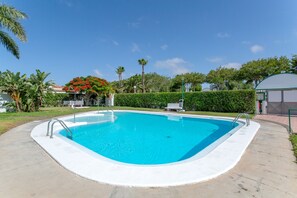 A rectangular swimming pool with a white edge, surrounded by a concrete deck. - Holiday Home “La Casa Blanca” with Shared Pool, Wi-Fi, and Air Conditioning (San Bartolomé de Tirajana)