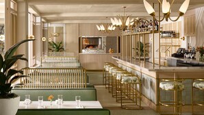 A restaurant with a bar area, seating, and a counter with a menu. - PGA National Cottage | Pool, Spa & PGA Golf (Palm Beach Gardens)