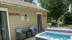 A hot tub and outdoor seating area with a wooden deck, a grill, and a sign indicating hot tub safety rules. - Private Oasis Awaits ! Hot Tub, Fire Pit, nap in the Hammock under the trees (Canadensis)