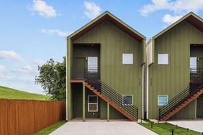 A building with two identical units, each with a balcony and a staircase. - 3BR Modern Home 15 Min to NRG, Downtown & Hobby (Houston)