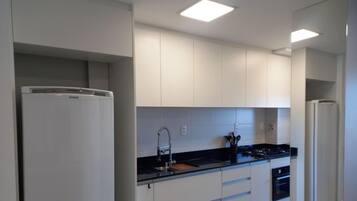 Premium Apartment, Jetted Tub, Beach View | Private kitchen | Fridge, microwave, cookware/dishes/utensils, dining tables