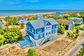 A two-story house with a balcony, a front porch, and a small pool. - "The Haven of Rest" – Multi-Gen Luxury Beach House w/ Elevator & Rooftop Views! (Milton)