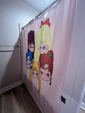 A shower curtain with anime characters. - Cozy Anime Beach House - Quick Walk to Beach (Bolivar Peninsula)