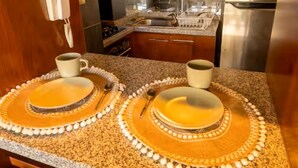 A kitchen with granite countertops, stainless steel appliances, and a double sink. - Charming Providencia Apartment, 1min from subway, close to costanera center, parking (Providencia)