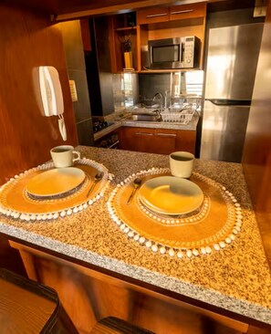 A kitchen with granite countertops, stainless steel appliances, and a double sink. - Charming Providencia Apartment, 1min from subway, close to costanera center, parking (Providencia)