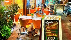 An outdoor cafe with tables and chairs, a menu board, and a sign for 'Aurea Cafe'. - Charming Providencia Apartment, 1min from subway, close to costanera center, parking (Providencia)