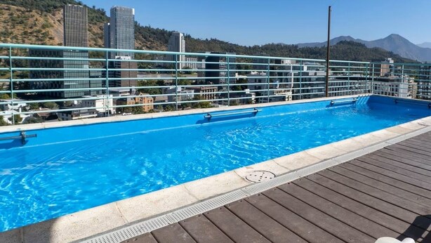A rooftop pool with a clear view of the cityscape and mountains in the background. - Charming Providencia Apartment, 1min from subway, close to costanera center, parking (Providencia)