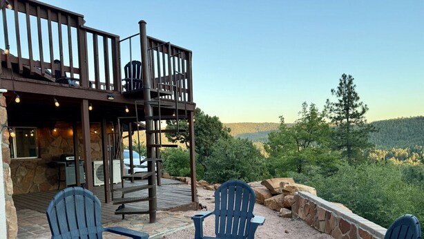 An outdoor seating area with Adirondack chairs and a fire pit, overlooking a scenic landscape. - Escape to quiet pines under star-filled skies (Pine)