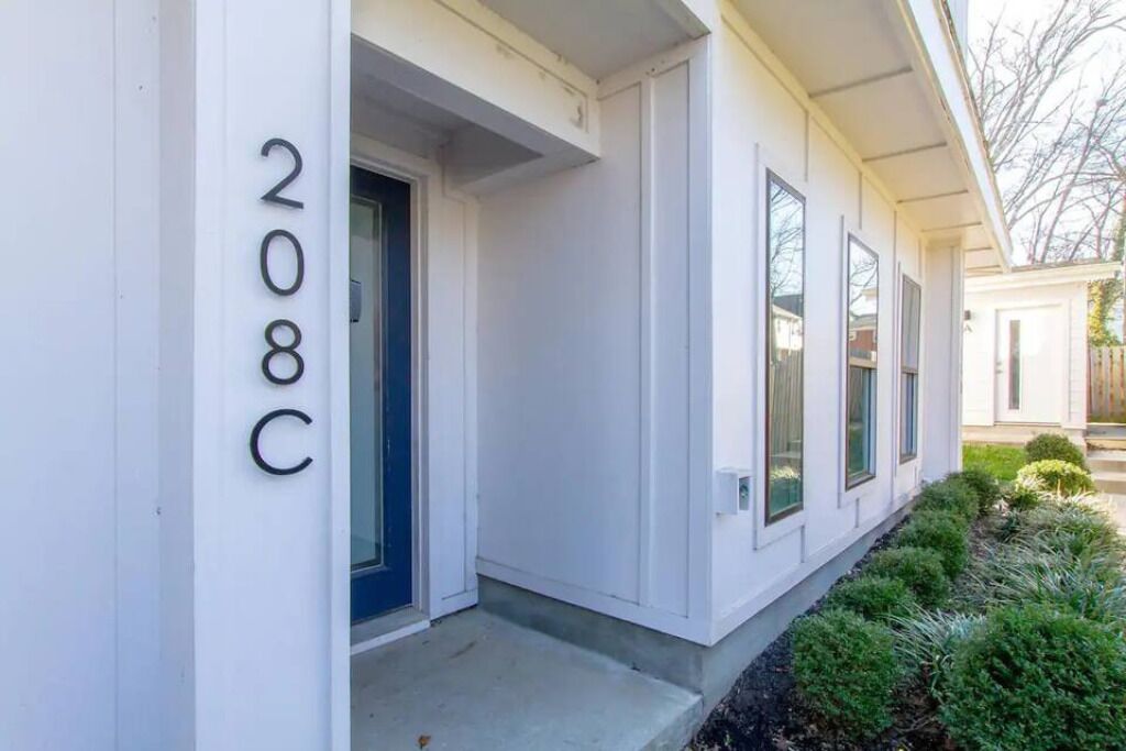 A white building with a number '208C' on the side.