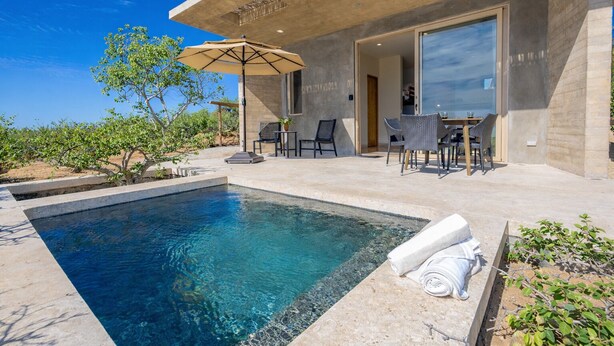 A modern outdoor pool area with a clear blue pool, a covered patio with outdoor furniture, and a view of the surrounding landscape. - Luxury Ocean View, Modern Mexican Design + Epic Views
5 bedrooms, Sleeps 16 (playa tortuga)