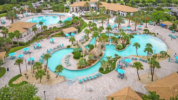 A resort with multiple swimming pools, palm trees, and a golf course in the background. - 8BR family retreat w/ game room & pool (Four Corners)