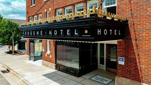 A brick building with a marquee-style entrance labeled 'Eugene Hotel.' - Eugene Hotel (Monroe)