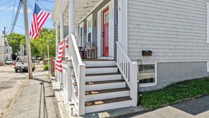 A house with a porch, steps, and a red door. - NEW - Sleeps 12, Fun Yard, Fire Pit Walk to Water! (Bristol)