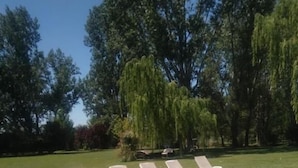 A swimming pool with lounge chairs and trees in the background. - La Matera Posada de Campo (San Rafael)