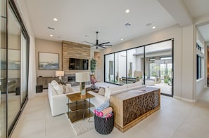 A modern living room with a sofa, coffee table, and a fireplace. - NEW Luxury|Pool|Spa|Sevens Escape at Sereno Canyon (Scottsdale)