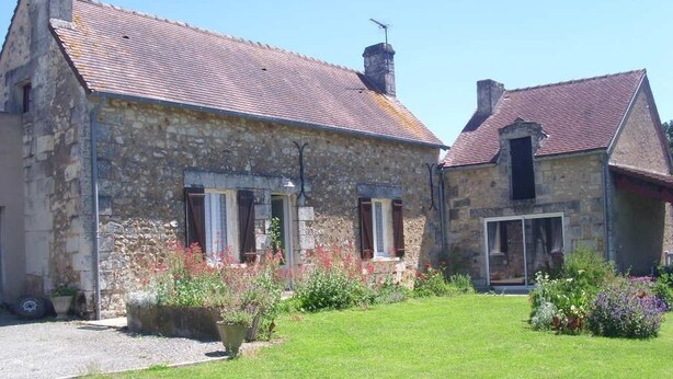 A stone building with a tiled roof, a grassy yard, and potted plants. - This is Paradise (SENILLE-SAINT-SAUVEUR)