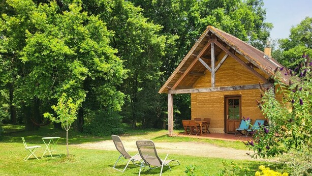 A rustic wooden cabin with a porch, surrounded by lush greenery and a well-maintained lawn. - Asia - BUSSIERE (LA) (BUSSIERE (LA))