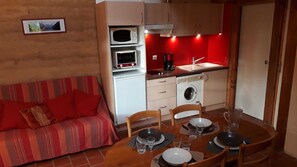 A compact living space with a kitchenette, a dining area, and a sofa. - Europe - BUSSIERE (LA) (BUSSIERE (LA))