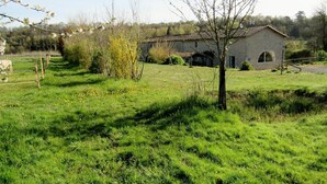 A rural property with a stone building, open fields, and a tree in the foreground. - Le Moulin de Chaume - CHAMPAGNE-SAINT-HILAIRE (CHAMPAGNE-SAINT-HILAIRE)