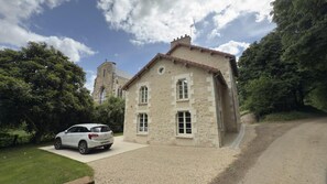 A two-story stone house with a gravel driveway and a parked car. - Au clair de la Rhune (MARCAY)