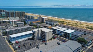 Une zone urbaine côtière comprenant des bâtiments, un parking et une plage.