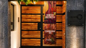 A wooden door with a vertical banner featuring artwork and text, a black sign with 'noox BERLIN 52', and a tiled floor. - Frida's Favorite Loft in Coyoacan, walk to Frida Kahlo's "Casa Azul" Museum. (Ciudad de México)