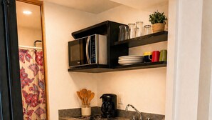 A compact kitchen with a microwave, coffee maker, and a sink. - Frida's Favorite Loft in Coyoacan, walk to Frida Kahlo's "Casa Azul" Museum. (Ciudad de México)