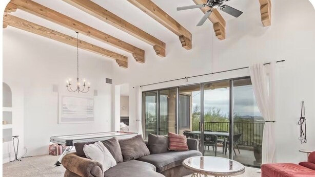 A spacious living area with a sectional sofa, a round coffee table, and a dining table. - Desert Escape in the Foothills!
Family friendly with pool and views (Tucson)