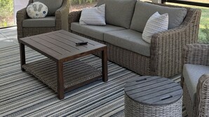 A room with a sofa, a coffee table, and a wicker chair. - Newly built 2bed/2bath house on Dataw Island; TWO WEEK MINIMUM (Saint Helena Island)